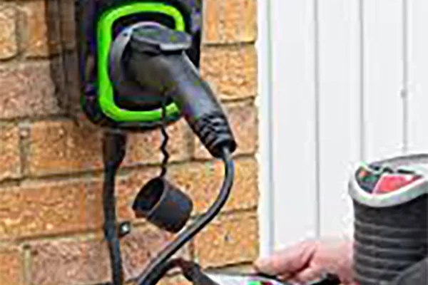 Technician testing an outdoor electrical charging point