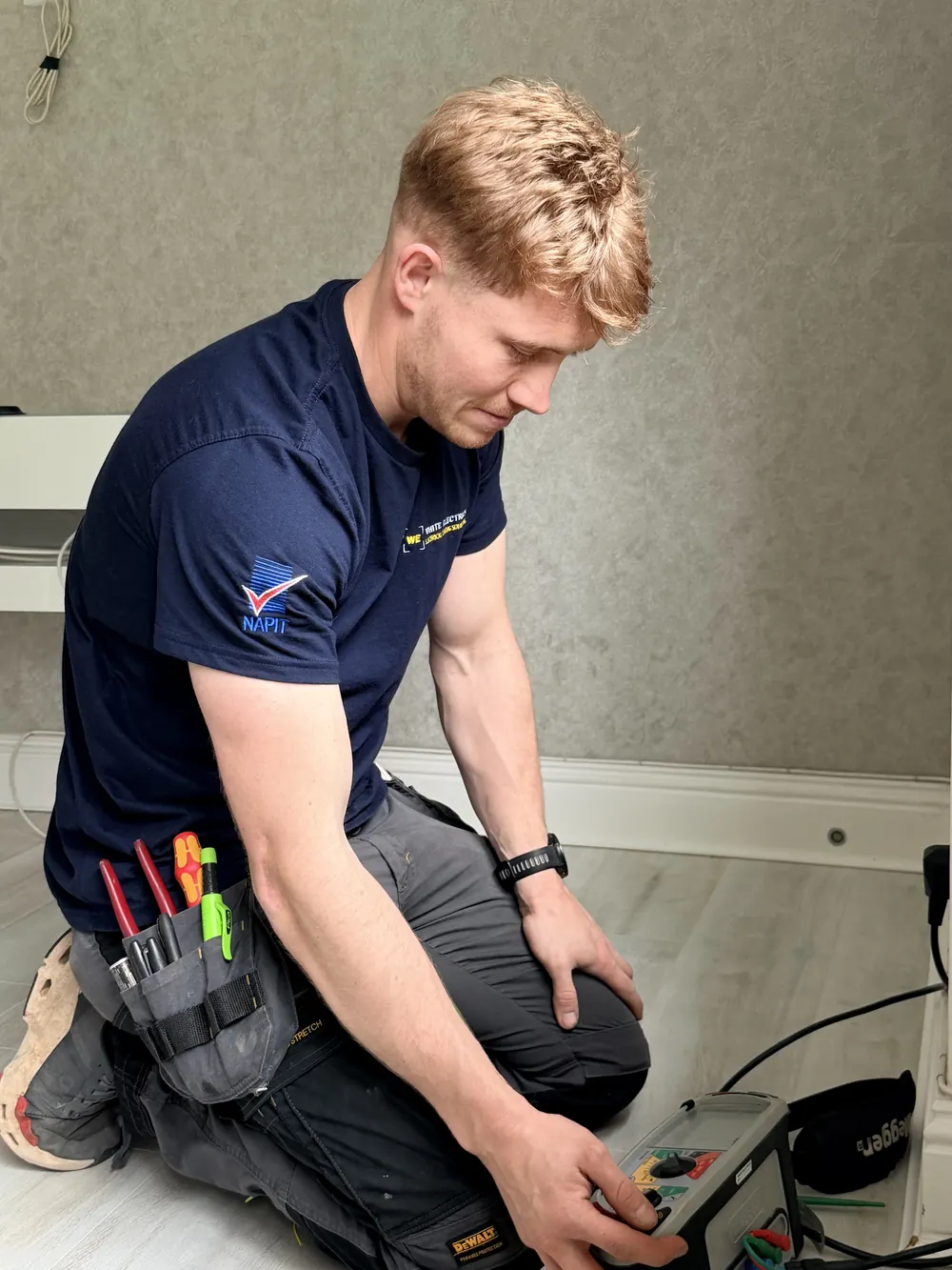 Greg White of White Electrics setting up electrical test equipment on site